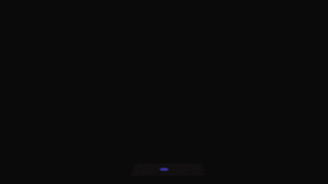 a man checking his computer in the dark